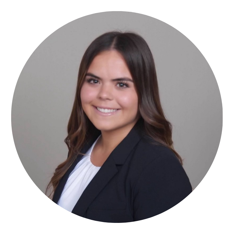 Janessa Barton headshot - woman with long brown hair, a white shirt and black blazer