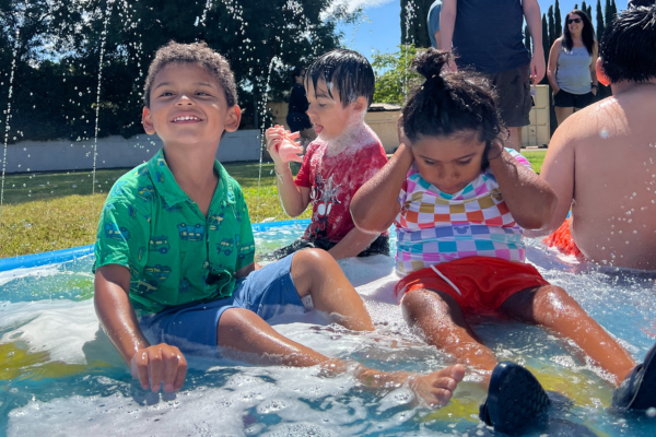 Children smiling while playing in water