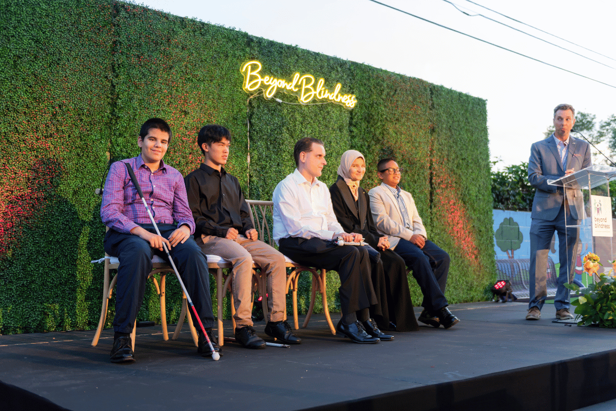 A panel of 5 on stage, and one man at a podium