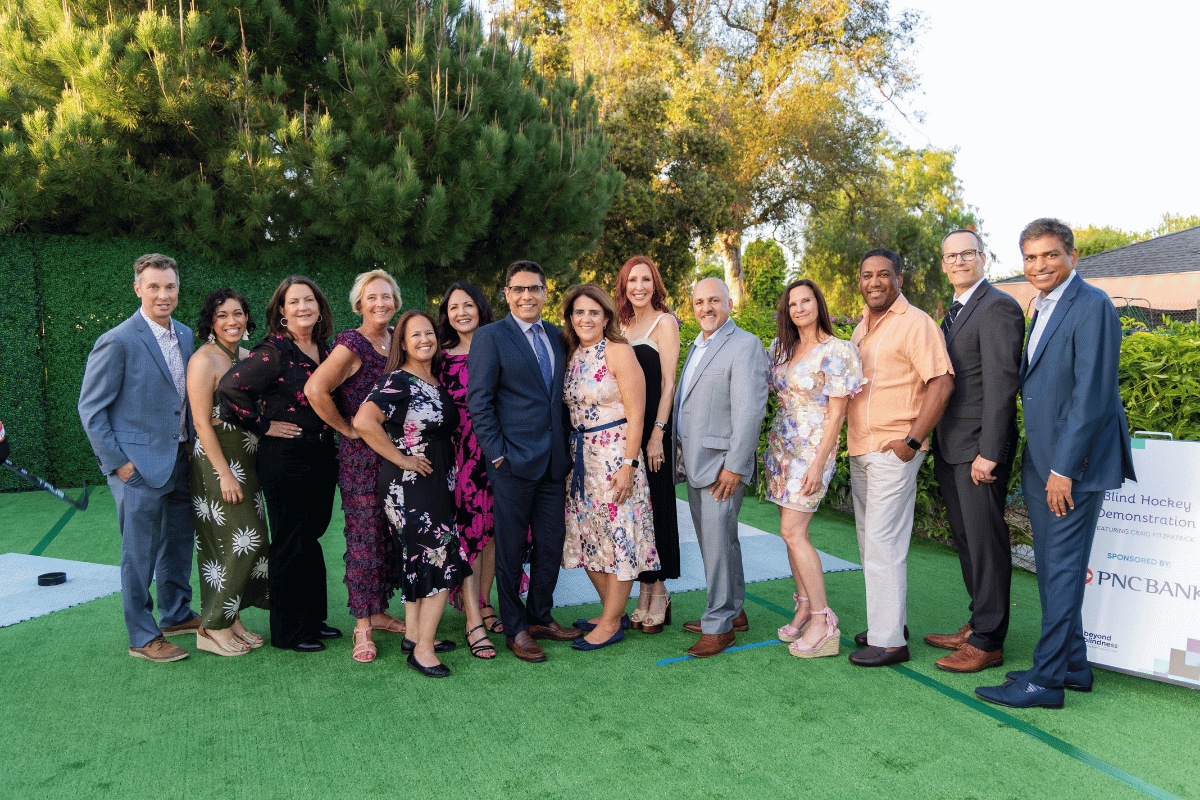 Large group of people post in a garden