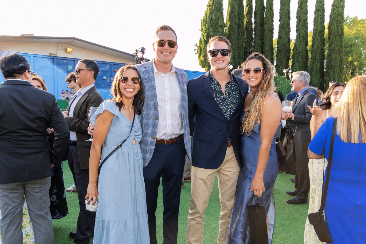 Guests pose for a photo in a garden setting