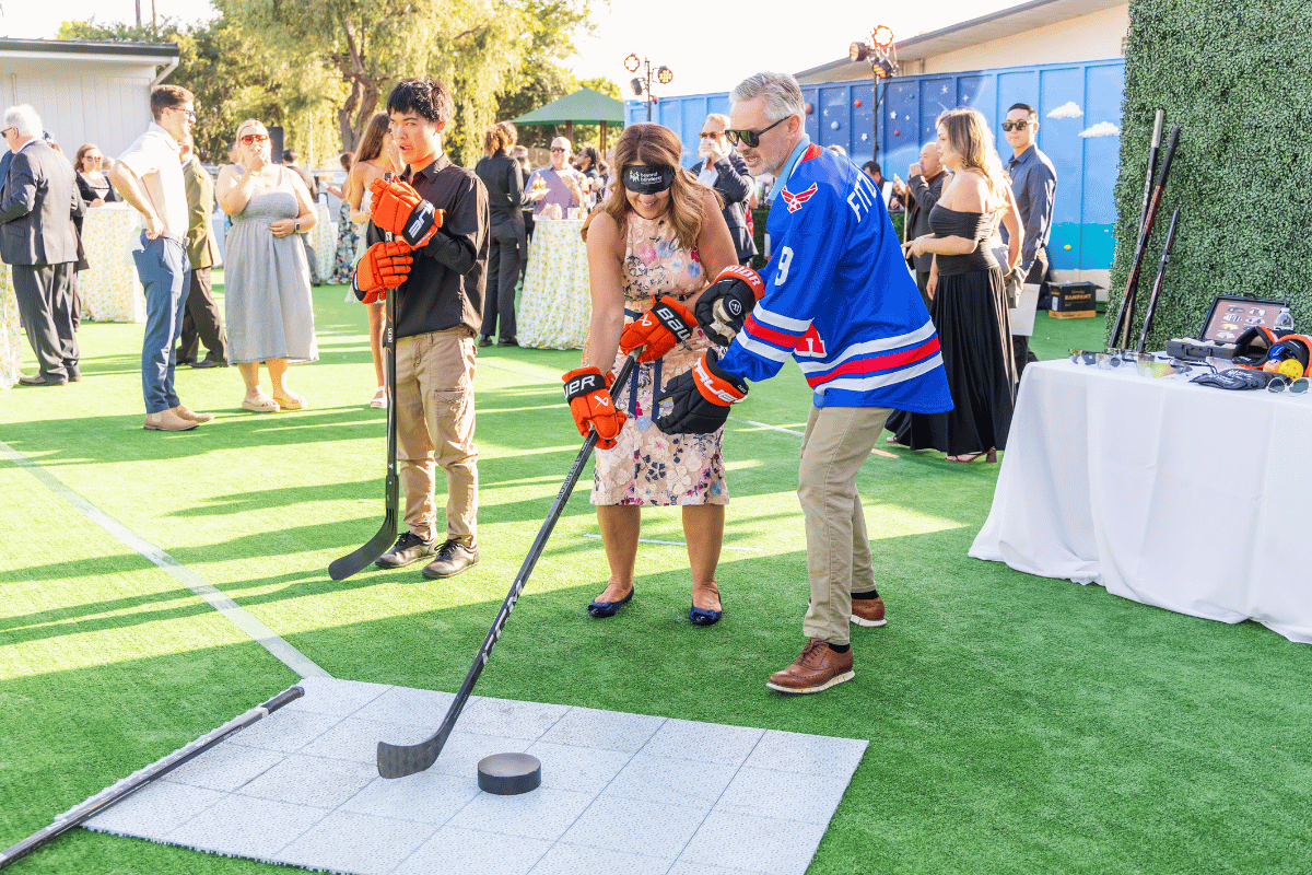 A woman attempts a blind hockey demo