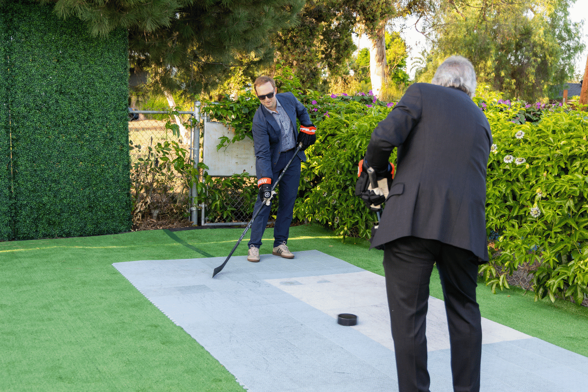 Two people passing hockey puck