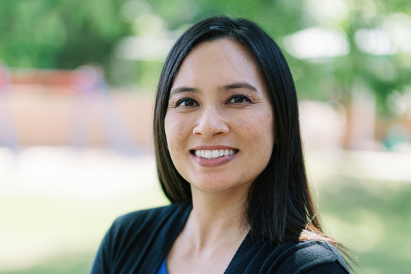 Professional headshot of a woman wearing a black sweater.
